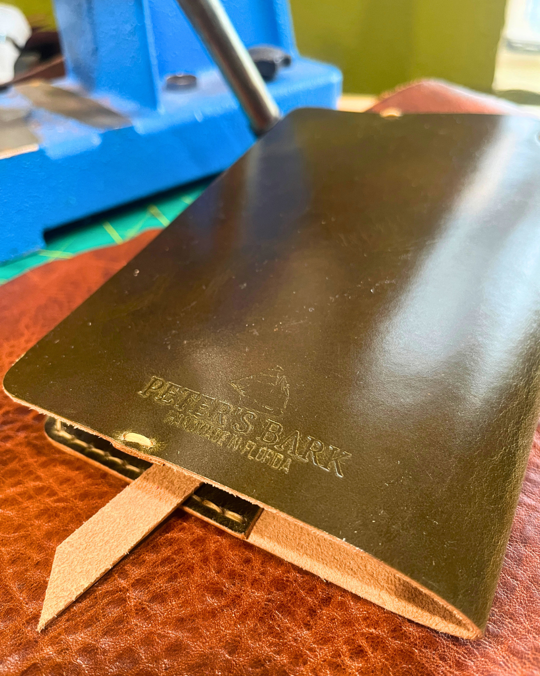 Green leather notebook with 'Peter's Bark' branding on a textured surface.